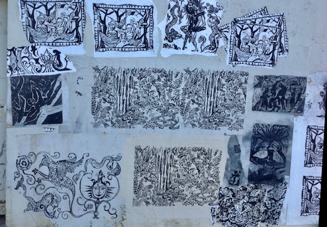 Darbury in front of wall with prints.